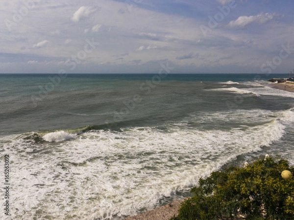 Fototapeta Rough and choppy sea with waves and cloudy sky