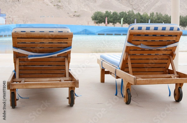 Fototapeta Swimming pool and deck chairs at the resort. United Arab Emirates