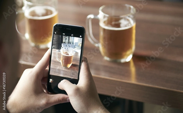 Fototapeta Close-up photo of a man taking a beer cup