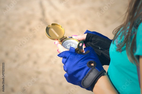 Fototapeta Tourist woman holding compass in hands close up. Travel concept.