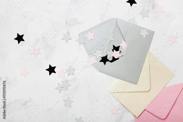 Fototapeta Opened envelope with colorful stars decoration top view. Mail and correspondence concept. Flat lay.