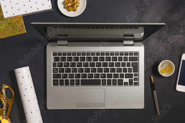 Fototapeta Modern business desk from above with Christmas decoration on dark background