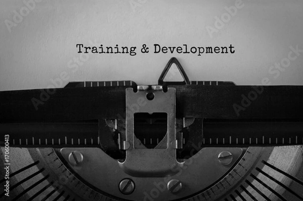 Fototapeta Text Training and Development typed on retro typewriter