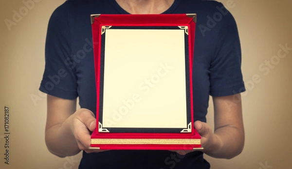 Fototapeta Woman Holding A Commemorative Plaque In Her Hands 