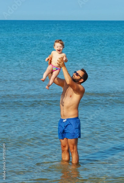 Fototapeta Dad and daughter playing in the sea