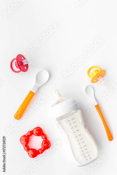 Fototapeta children feeding with breastmilk or infant formula powdered baby milk and toys on white background top view space for text