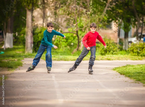 Obraz Three children on inline skates in park