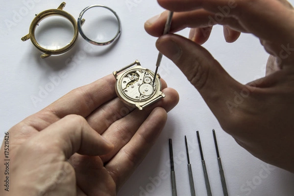 Fototapeta Watchmaker is repairing the mechanical watches in his workshop