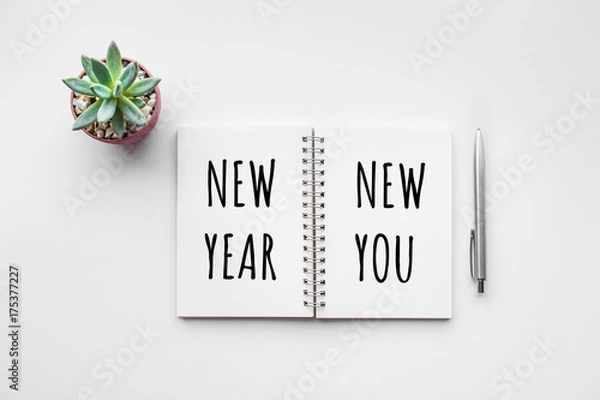 Fototapeta New year new you text on notepad with office accessories.Business motivation,inspiration.