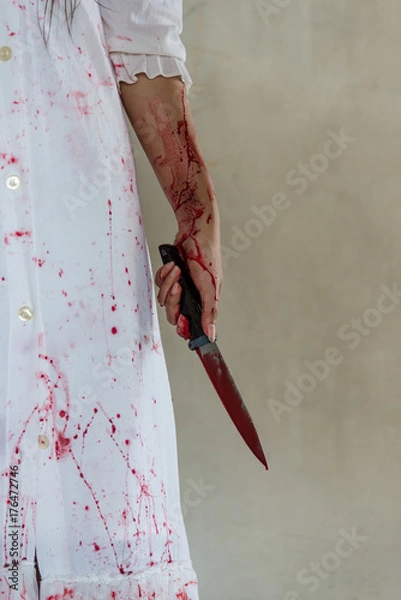 Fototapeta Woman holding knife with blood