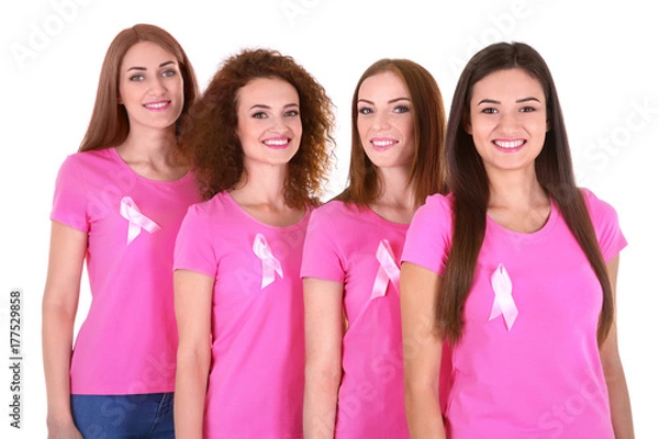 Fototapeta Young women in pink t-shirts on white background. Breast cancer awareness concept