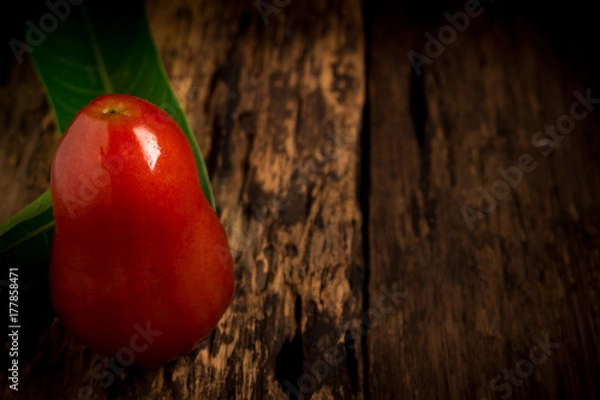 Fototapeta rose apple on wood. dark. night