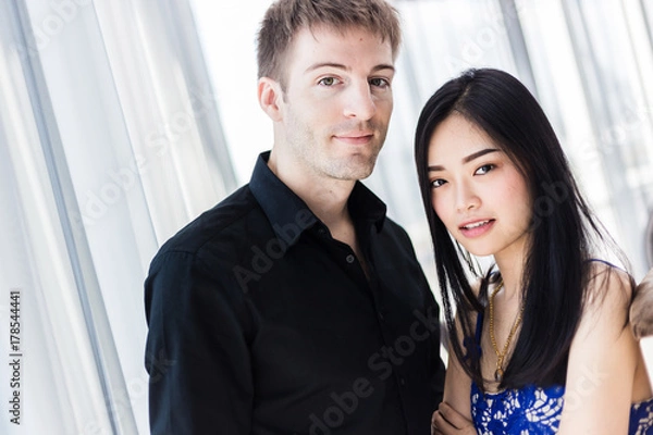 Fototapeta Portrait of beautiful young couple looking at camera