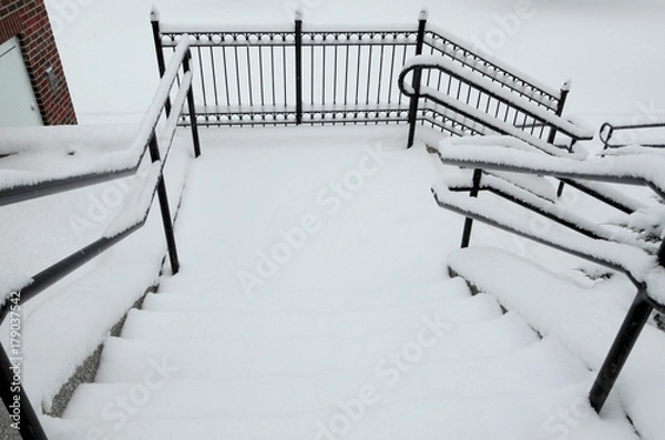 Fototapeta Snowy steps provide a treacherous pathway