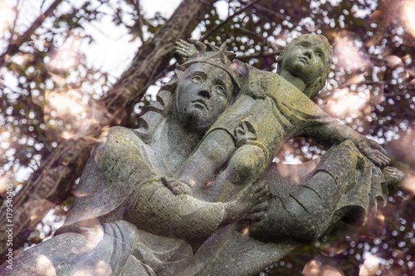 Fototapeta mary and jesus statue with bokeh