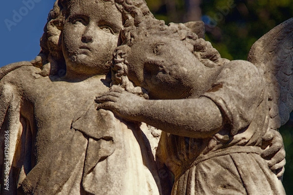 Fototapeta Ancient stone statue of  little angels as symbol of guards for children (love, faith, hope, religion, Christianity, good concept)