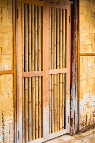 Fototapeta View of the bamboo door in Louangphabang, Laos. Close-up. Vertical.