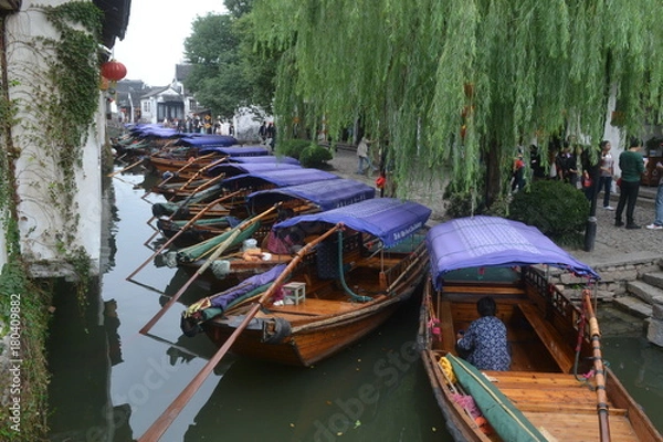 Fototapeta Water taxi assembly and waiting for customers beside a river in Zhou Zhuang, China.