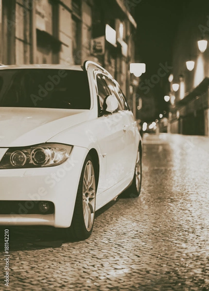 Fototapeta White car at lonely street at night.