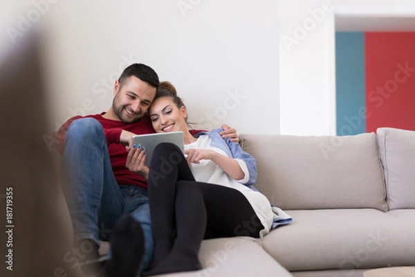 Obraz couple relaxing at  home with tablet computers