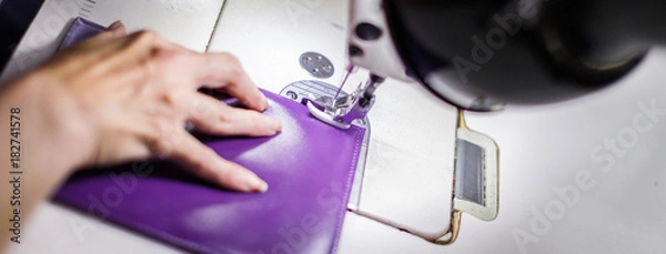 Fototapeta female hands stitching a purse