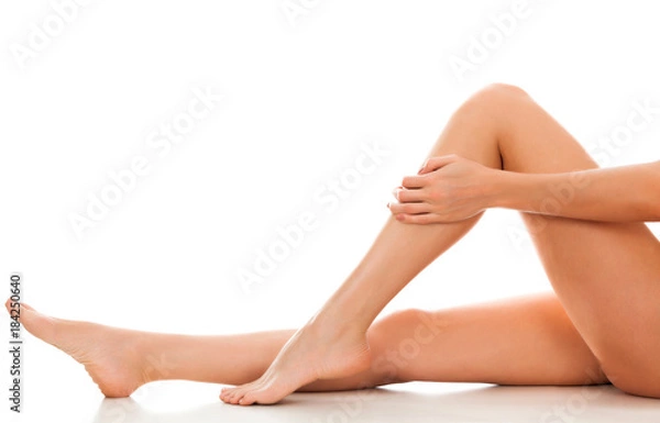 Fototapeta Beautiful smooth and shaved woman's legs. Isolated on white background. Skincare treatment concept