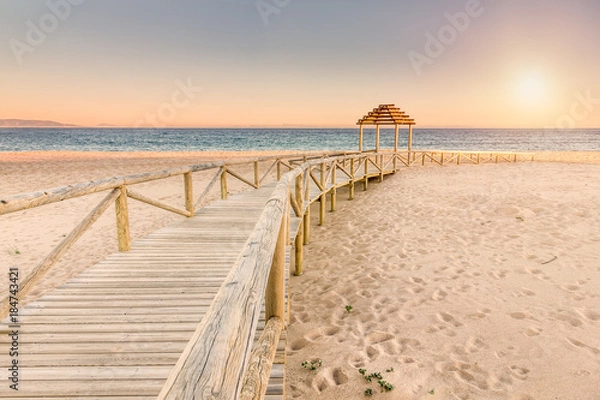 Fototapeta Wooden boardwalk to the beach. Idyllic scene