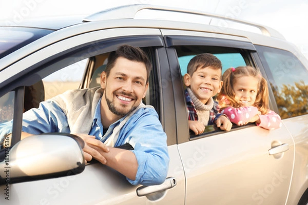 Obraz Young man with children in car, outdoors