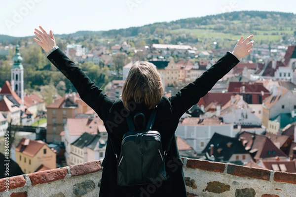 Fototapeta Woman raising arms enjoying sunlight