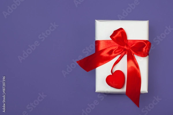 Fototapeta White gift box with red heart on ultra violet background. St. valentine's greeting concept. top view, flat lay