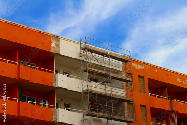 Fototapeta Renovation of an apartment building with scaffolding