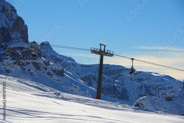 Fototapeta Skiers on the Cable car to the Groste-pass, Madonna di Campiglio, skiers on slope in ski resort Italian Alps in sunny day in Madonna di Campiglio,italy