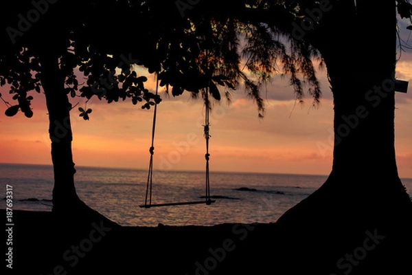 Fototapeta  lonely  cradle on the beach with sunset background