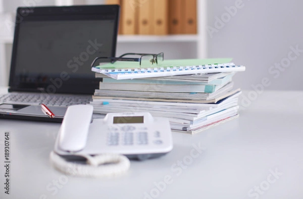 Fototapeta Office table with blank notepad and laptop