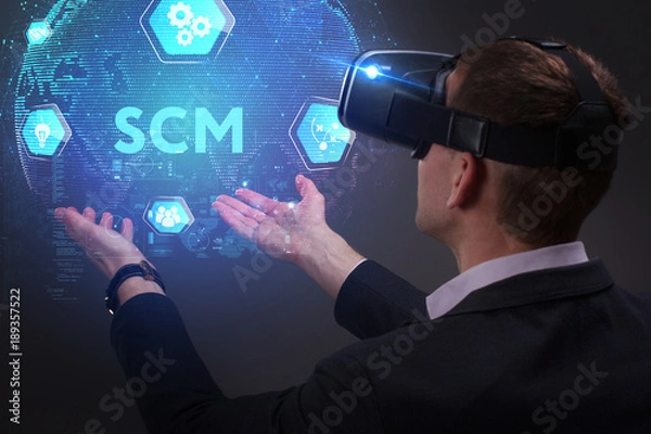 Fototapeta Business, Technology, Internet and network concept. Young businessman working on a virtual screen of the future and sees the inscription: SCM