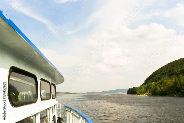 Obraz Part of steamer, floating on the Volga river and beautiful cloudy sky in summer day.