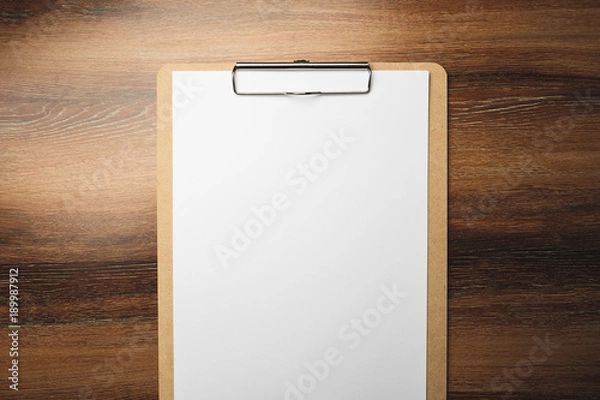 Fototapeta Clipboard with empty white paper on wooden table