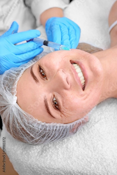 Fototapeta Beautician making injection in woman's face, closeup. Biorevitalization procedure