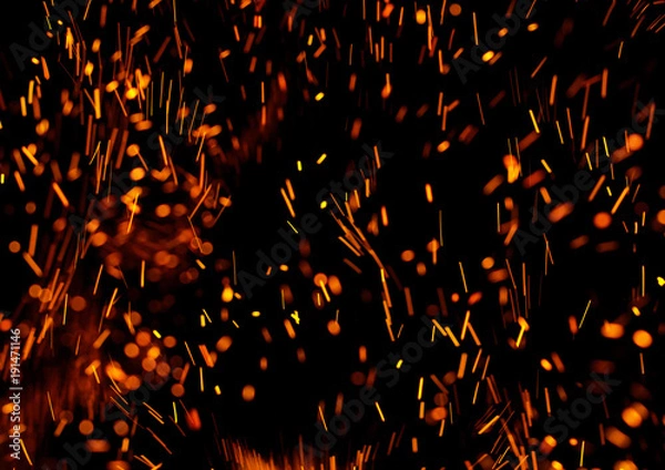 Fototapeta flame of fire with sparks on a black background