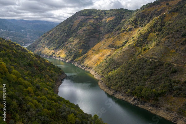 Fototapeta The sun of an autumn afternoon gilds the slopes of the Sil Canyon