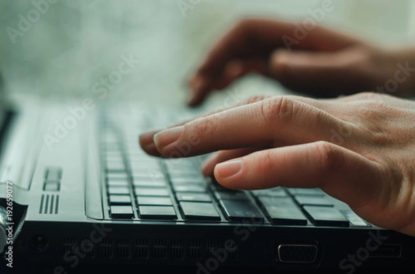 Fototapeta Close-up of typing female hands on keyboard