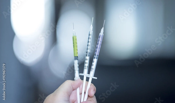 Fototapeta A Doctor prepared syringe of vaccine to injunction patient