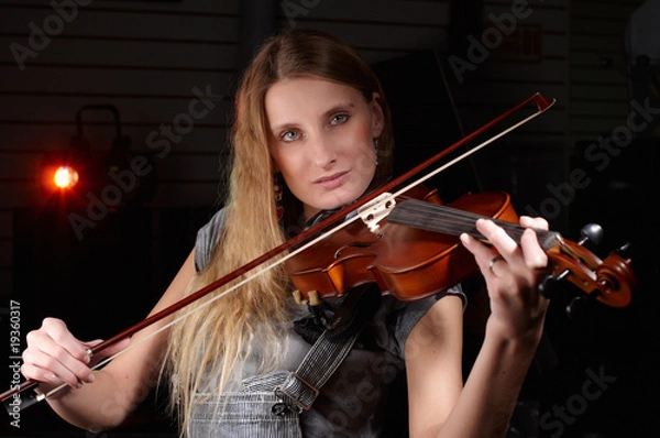 Fototapeta young female play on violin in music study