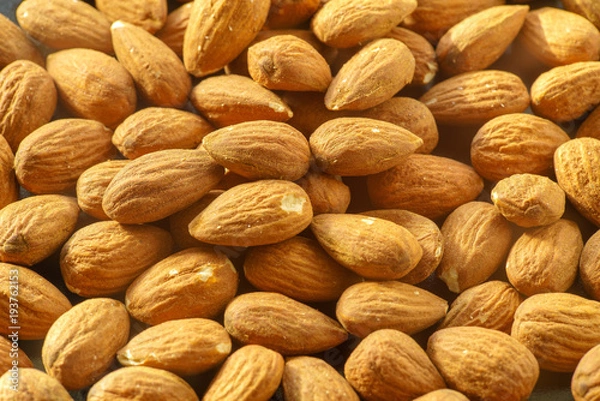 Fototapeta Almonds nuts. A close-up photograph. Unrefined whole kernel