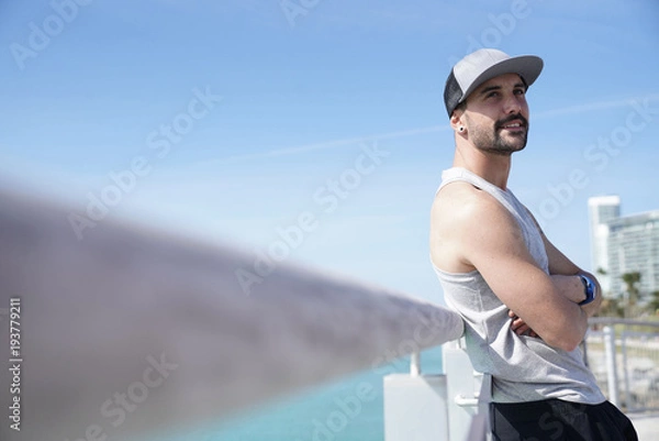 Fototapeta Portrait of athletic guy with baseball cap