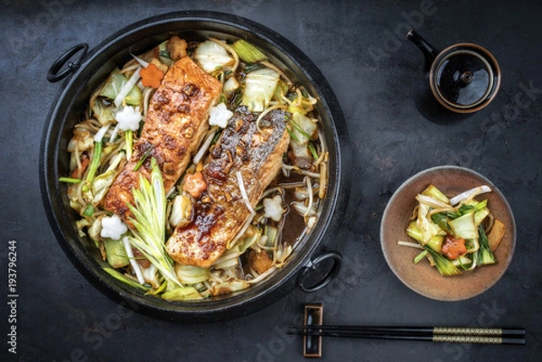 Obraz Japanese chan chan yaki hot pot with salmon fillet as top view in traditional cast iron pot