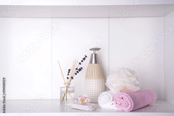 Fototapeta Various spa and beauty threatment products on white shelf