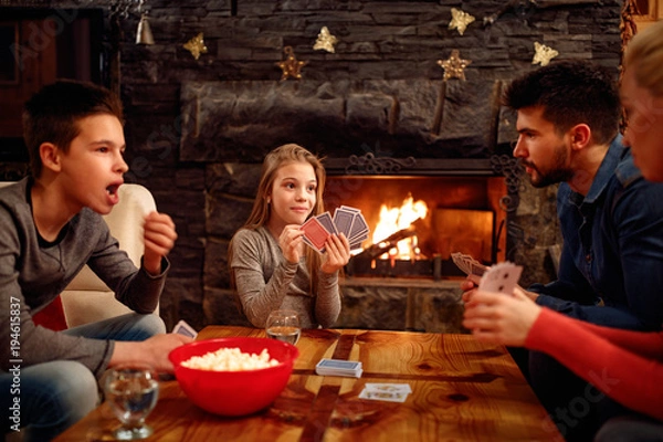 Fototapeta family playing cards at home