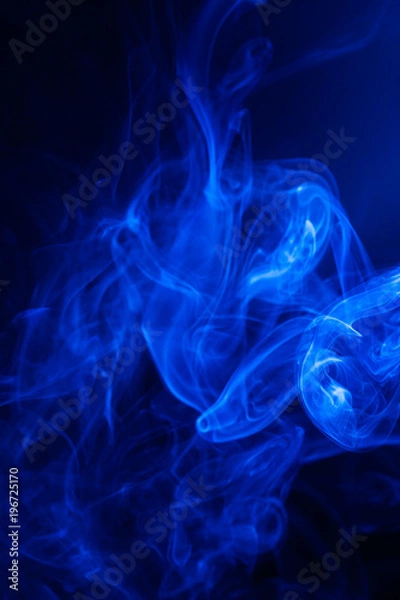 Fototapeta Blue smoke on black background.