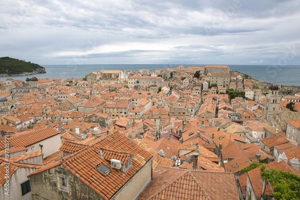 Fototapeta View over the orange rooftops of old town Dubrovnik from the ancient city wall with cloudy weather, Croatia